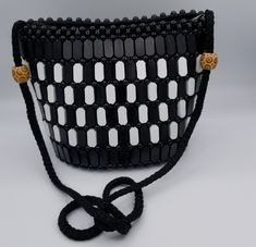 Elegant rich  African beads buckets shoulder bag .100% African weaving .  Its interior is well lined with a black silk fabric for a smooth feel and convenient wiping.  This shoulder bag  is for anyone who dares to be different and can be used for casual or a special occasion, day and night depending on your mood.  It can also be a gift from you to you or to others Rectangular Black Bucket Bag For Gift, Elegant Black Bucket Bag For Gift, Beaded Bucket Shoulder Bag For Everyday Use, Handmade Black Crossbody Bucket Bag, Everyday Beaded Bucket Shoulder Bag, Black Bucket-shaped Evening Bag, Black Bucket Evening Bag For Formal Occasions, Black Formal Bucket Evening Bag, Formal Black Bucket Evening Bag