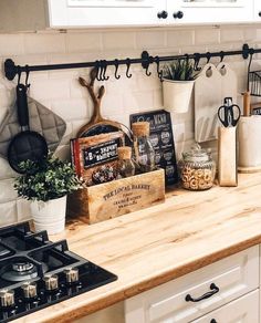 the kitchen counter is covered with pots, pans and other cooking utensils