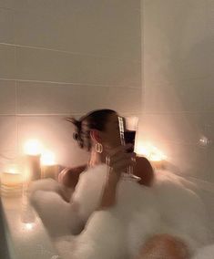 a woman taking a selfie in a bubble bath