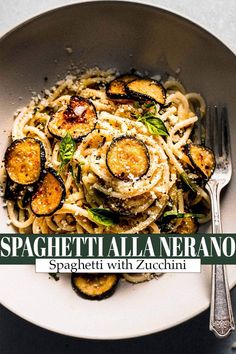 spaghetti with zucchini and parmesan cheese in a white bowl on a table