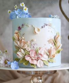 there is a cake decorated with flowers on the top and bottom tier, but no one has seen it