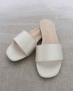 Classic slide flat sandals for casual and dressy look. Simple and easy wear for brides, bridesmaids and wedding parties.DETAILS:COLORS AVAILABLE: Ivory, Light Blue, White, Pink, and ChampagneUPPER: Synthetic upper and liningMATERIALS: Mandmade outsole STYLE NAME: EVELYN Flats For Wedding, Wedding Afterparty, Bridesmaid Sandals, Ivory Flats, Wedding After Party, Slip On Sandals, Satin Slip, Dress Ideas, Easy Wear