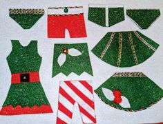 the paper doll is made up of green and red christmas outfits, stockings, hats, and candy canes