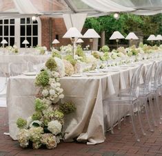 the tables are covered with white and green flowers