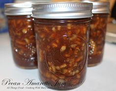 three jars filled with food sitting on top of a table