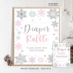 a snowflake themed baby shower sign and ticket card with pine cones on the side