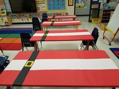 a classroom filled with lots of desks covered in red, white and blue sheets