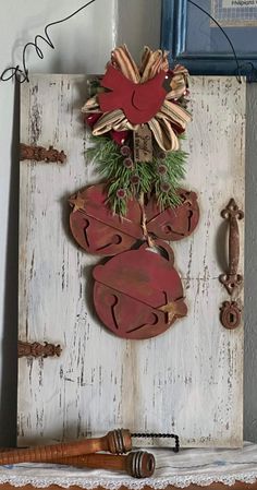 an old door is decorated with red and green decorations for the holiday season, along with a pair of wooden shoes