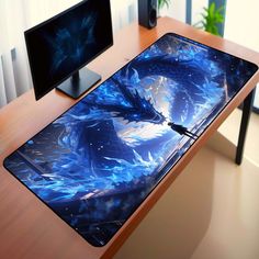 a computer desk with two monitors and a large blue dragon mouse pad on top of it