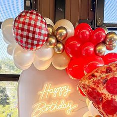 a birthday sign with balloons and pizza on it