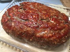 a large meatloaf sitting on top of a glass tray