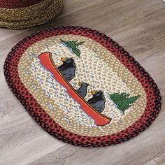 two round rugs on the floor with black bears in canoe and trees around them