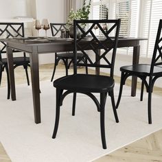 a dining room table and chairs with white rug