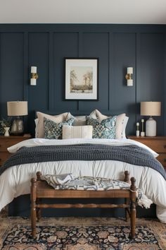 a bedroom with blue walls and white bedding