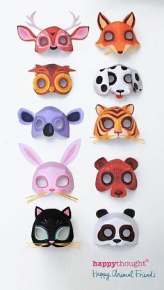 a group of animal masks sitting on top of a white table next to each other