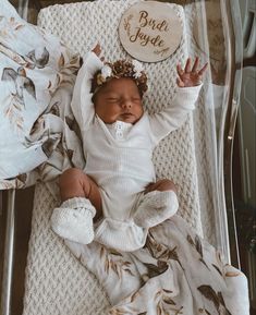 a baby is laying down in a clear box with the name bird inside on it