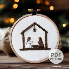 a cross stitch nativity scene with the birth of jesus