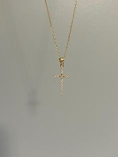 Dainty and so sparkly, our cross necklace is a classic and perfect for everyday wear! Information: ✨ Sterling Silver (925 stamped) | 14K Gold Plated ✨ AAA grade Cubic Zirconia gemstones ✨ Adjustable length: 16" - 18" ✨ Hypoallergenic ✨ Tarnish resistant ✨ Water friendly Our cross necklace is dainty, it measures roughly the size of a quarter in height. It's ideal for those that love small charms. At the center of the cross, we have added a North Star design which according to the scripture, allows people to receive guidance in their journey. The necklace has great craftsmanship and attention to detail, using a pavé design to encrust the gemstones, giving the cross a lot of shine and sparkle. Plus, the necklace is adjustable. You have the ability to wear it at 16", 17" or 18" allowing you to Dainty Cross Necklace For First Communion, White Cross Pendant Necklace For Baptism, Dainty Cross Necklace For Baptism, White Cross Necklace For Baptism, Gold Crucifix Necklace, Small Cross Necklace, Cross Necklace Gold, Cross Charm Necklace, Necklace Christian