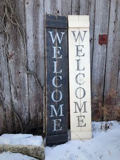 two wooden signs that say welcome and welcome