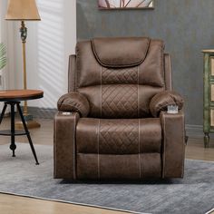 a brown recliner chair sitting on top of a rug