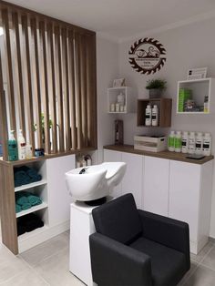 a chair and sink in a room with wooden slats on the wall behind it