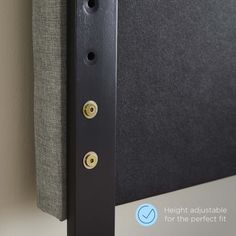 a close up view of the side of a black headboard with buttons on it