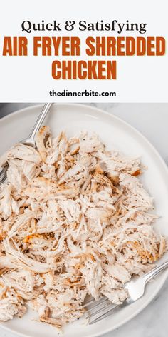 a white plate topped with shredded chicken on top of a table