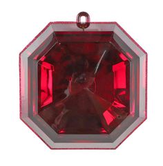 a red and silver pendant with an image of a woman on it