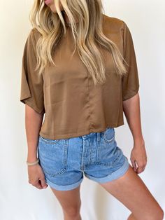 From workwear to date night this silky blouse is a no brainer! It has longer short sleeves, a middle seam and a keyhole button back. Styled with the Perfect Pair Rolled Denim Shorts and Erica Embroidered Slides. beautiful mocha/coffee color slightly cropped fit 58% polyester, 42% rayon care instructions: hand wash cold, hang dry true to size Paige is 5'6" wearing a small Brown Button-up Summer Tops, Spring Brown Button-up Top, Brown Button-up Beach Top, Khaki Relaxed Fit Button-up Tops, Brown Relaxed Fit Button-up Top, Mocha Coffee, Silky Blouse, Coffee Colour, Long Shorts