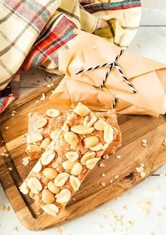 a wooden cutting board topped with sliced almond bars