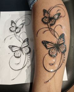 a woman's leg with tattoos on it and two butterflies flying over the top