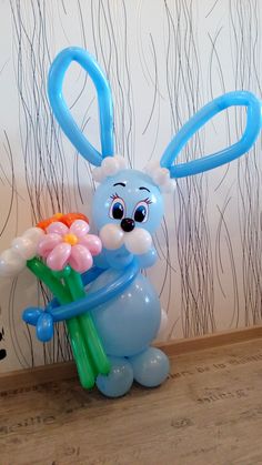 a balloon bunny with flowers in it's hands