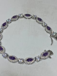 Vintage Purple Amethyst Bracelet 925 Sterling Silver Tennis This amethyst bracelet is very lively and bright. The stones are deep colors and well matched. The sterling silver is plated with rhodium to protect the bracelet from tarnish and give the appearance of white gold. 7.5 inches All jewelry is shipped in a nice gift box. Check out our over a THOUSAND great reviews Engraving is $4 per letter and is not always perfect depending on the piece. It can take a few days if the jeweler is busy. This Luxury Purple Sterling Silver Bracelets, Elegant Silver Tennis Bracelet With Amethyst, Elegant Purple Sterling Silver Jubilee Bracelet, Elegant Silver Amethyst Tennis Bracelet, Elegant Silver Tennis Bracelet, Elegant Purple Cubic Zirconia Bracelets, Purple Cubic Zirconia Bracelets As Gift, Purple Cubic Zirconia Bracelet As Gift, Purple Cubic Zirconia Bracelets For Gift