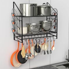 a rack with pots and pans hanging on the wall