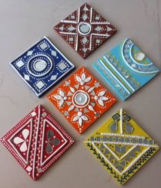 four different colored tile designs on a table