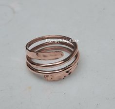 Pure Copper Wrap Ring, Arthritis Thumb Ring, Toe Ring, Finger Ring, Solid Copper Ring, Hammered Ring, Healing Jewelry, Copper Jewelry Gift. Handmade Ring Material:   Copper  Theme: Love & Friendship Category: Spinner :- Free Shipping :- You are always special for us. :- Shipping time is 1-3 days.  FEEDBACK We Always Believe In Customer Satisfaction, Your Feedback Is Very Important & Valuable For A Successful , So Please Drop A Feedback If You Are Liking Or Disliking Our Product. OR What Changes We Should Do In Our Bulk Collection Of Jewelry. Your Advise Is Very Precious For Us. Thank You So Much For Giving Your Precious Time To My Firm Our products are totally handmade and made with high quality gemstones and sterling silver. PLEASE GIVE ME A CHANCE ! Have a Nice Day ! Spinner rings featur Adjustable Copper Rings For Wedding, Adjustable Copper Wedding Rings, Handmade Spiral Rings For Gifts, Handmade Spiral Rings For Anniversary, Handmade Spiral Rings For Gift, Handmade Spiral Anniversary Rings, Hand Wrapped Spiral Rings As Gift, Handmade Rose Gold Toe Ring, Handmade Spiral Wedding Ring