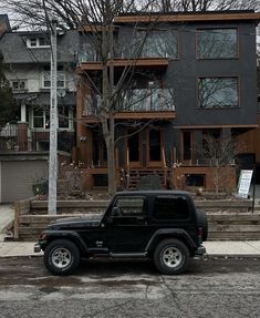 a black jeep parked in front of a house