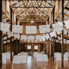 the inside of a barn decorated with white linens