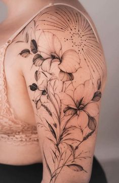 a woman's shoulder with flowers on it