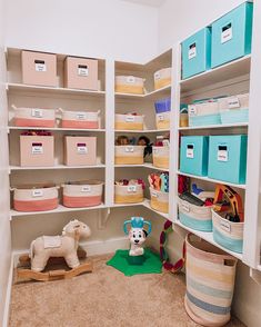 an organized closet with toys and storage bins on the shelves in front of it