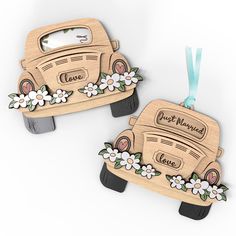 two wooden car ornaments with flowers and the words just married are hanging on a blue ribbon