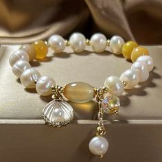 Add a touch of luxury to your look with this beautifully crafted bracelet. Designed to withstand the test of time and elevate any look. Natural fritillary, Agate, freshwater pearls Amber size: 8 mm Premium zinc alloy Elastic - Suitable for hand circumference: 14-18 CM Hypoallergenic, lead & nickel free *We carefully select each gemstone to offer gems with the best quality. As gemstones are natural materials, stone colors may vary slightly from the images, making this beautiful bracelet completely unique, just like you!If you aren't in LOVE with your purchase, please let us know within 30 days of receiving your item, and you'll receive a stress-free refund. Natural Stones Pearl Bracelet As A Gift, Elegant Natural Stones Beaded Bracelet, Gold Agate Crystal Bracelet Gift, Elegant Agate Beaded Bracelets For Gift, Elegant Natural Stone Beaded Bracelets For Gift, Elegant Beaded Bracelets With Natural Stones For Gift, Elegant Pearl Bracelet With Natural Stones For Gift, Gold Pearl Bracelet With Natural Stones As Gift, Elegant Crystal Bracelet With 8mm Beads