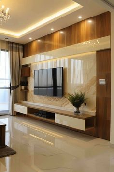 a living room with a large flat screen tv on top of a wooden entertainment center