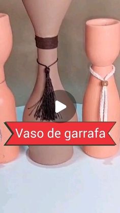 three vases with tassels on them sitting next to each other and the words vaso de garafa written in spanish