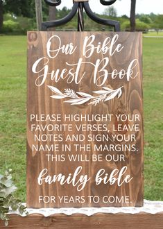 a wooden sign that says our bible guest book please hight your favorite verse, leave notes in the margings this will be our family bible for years to come