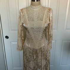 Brand: Jessica Mcclintock Era: 1980s Color: Ivory Material: Satin And Lace Size: 4 B 15.5 W 14" Dropped Waist Is 17" Condition: Excellent Vintage Condition, With No Noticeable Flaws Or Wear. Features: The Dress Features A Sophisticated High Neckline Adorned With Delicate Lace, Adding An Air Of Grace And Elegance. The Bodice Is Beautifully Crafted With Intricate Lace Detailing, Showcasing The Impeccable Craftsmanship Of Jessica Mcclintock Designs. The Long Sleeves Are Made From Luxurious Fabric, Complemented With Lace Cuffs, Enhancing The Overall Vintage Charm. The Dress Has A Series Of Buttons Running Down The Back, Adding A Touch Of Vintage Sophistication And Ensuring A Secure Fit. The Sk Victorian Cream Dress For Party, Cream Party Gown With Lace Trim, Cream Gown With Lace Trim For Party, Vintage Victorian Dress For Spring Formal, Spring Vintage Victorian Dress For Formal Occasions, Cream Fitted Long Sleeve Vintage Dress, Spring Formal Vintage Victorian Dress, Fitted Long Sleeve Cream Vintage Dress, Cream Fitted Victorian Evening Dress