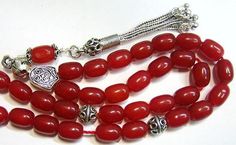 "Special from Swancollection : a magnificient Greek Komboloi - Worry beads Description : 1) Material : RED RUBILITE OF PRIME QUALITY 2) Tassel : Sterling Silver 3) General : 33 Oval beads Length 9 mm & Dia. 2mm 4) Sterling silver separators, Sterling shield and bead caps are in Sterling tassel Pictures describe best FREE SHIPPING WORLDWIDE This is a magnificient item that you will greatly enjoy or that would make a fantatstic gift on any occasion. My selling principle is : \" SATISFACTION OR Elegant Handmade Red Beads, Gems, And Cabochons, Red Hand-strung Beads For Jewelry Making, Red Large Beads For Jewelry Making, Traditional Red Round Beads, Gems, And Cabochons, Traditional Red Beads, Gems, And Cabochons, Red Spiritual Beads And Cabochons For Jewelry Making, Traditional Red Gemstone Beads, Red Gemstone Beads As Gift, Red Gemstone Beads For Gifts