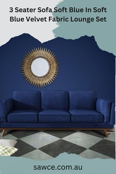 a blue velvet fabric sofa in front of a wall with a circular mirror on it