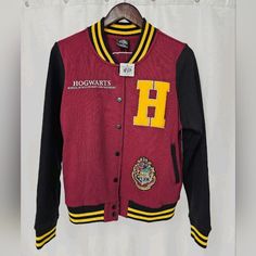 This Brand New Harry Potter Jacket Is Size Medium. It's A Cotton/Polyester Blend Fabric. You Will Go Out In Style With Its Deep Red/Maroon, Yellow And Black Details. This Jacket Will Surely Catch The Eye Of Every Harry Potter Fan. Harry Potter Jackets, Harry Potter Jacket, Varsity Jackets, Red Maroon, Yellow And Black, Harry Potter Fan, Go Out, The Eye, Deep Red