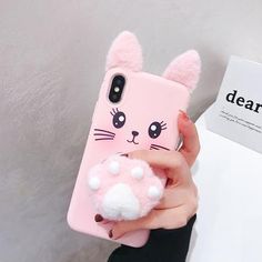 a person holding a pink phone case with a cat on it